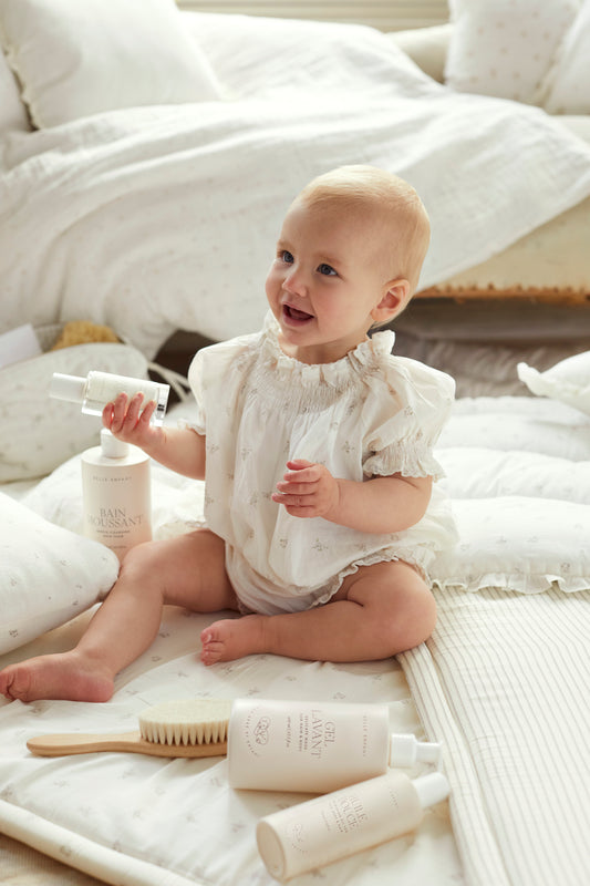 Baby enjoying Belle Enfant beauty products