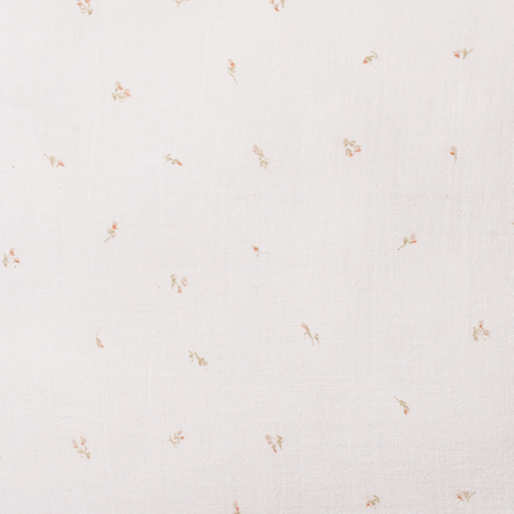 Close up of 100% cotton muslin pillow in pink rose print