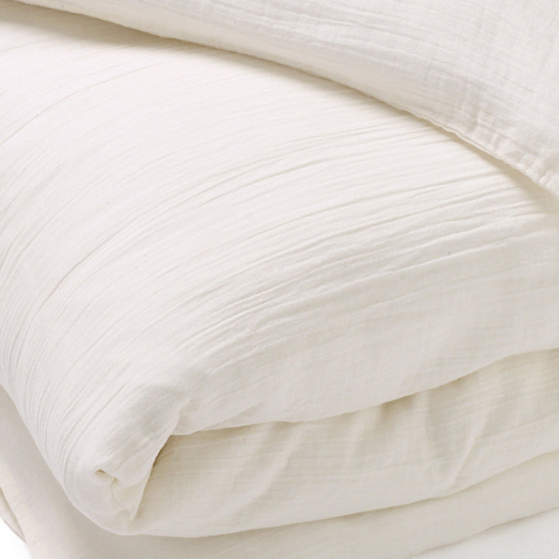 Close-up of the soft 100% cotton muslin fabric in cream