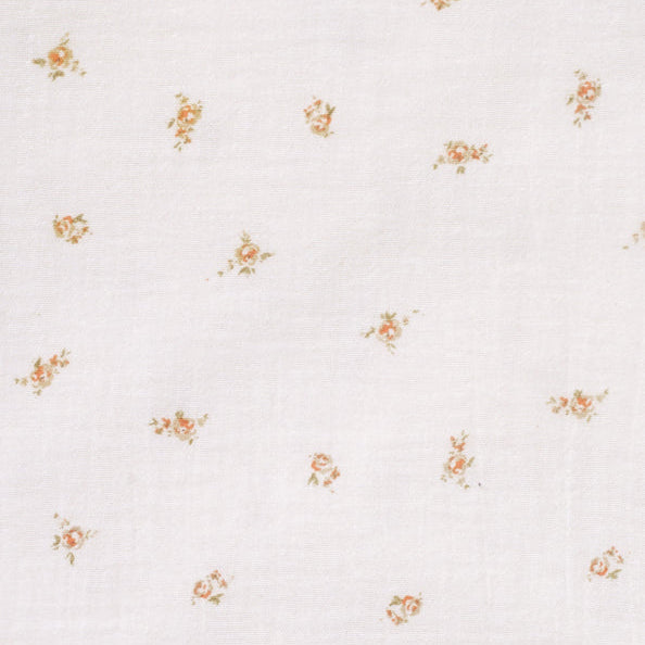 Close-up of the Pink Rose print on the 100% cotton muslin fitted cot sheet