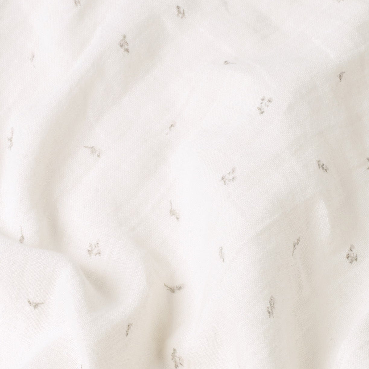 Close-up of soft 100% cotton muslin fabric on Belle Enfant baby bibs