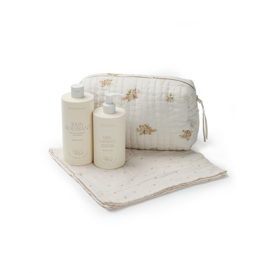 A beautiful baby set with a hand-quilted toiletry bag, Gel Lavant baby and toddler wash, Bain Moussant baby bubble bath, and muslin cloth squares.