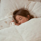 Child sleeping in luxuriously soft cotton bedding