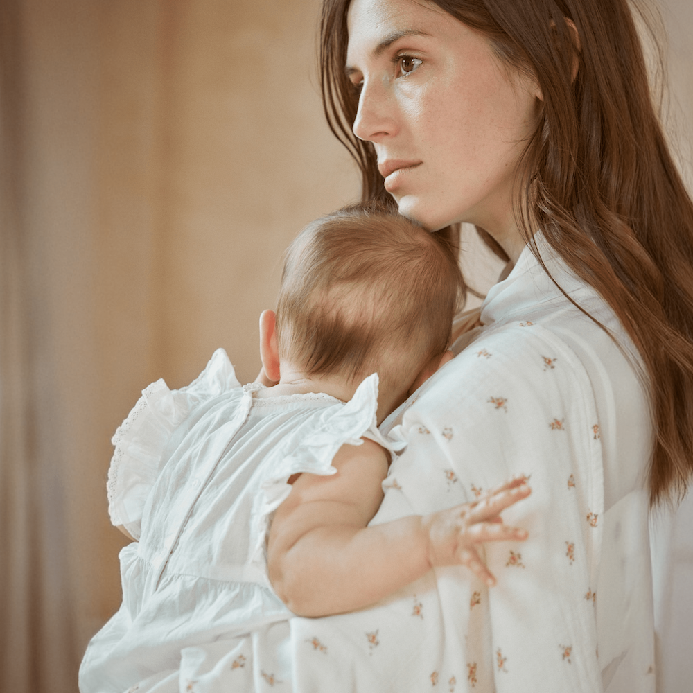 Mother and baby using 100% muslin cotton swaddle from Belle Enfant