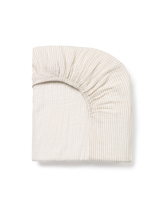 Belle Enfant fitted sheet with elasticated corners ensuring a secure fit on a cot mattress.