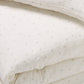 Close up of delicate taupe rosebud print in 100% cotton muslin duvet set for children
