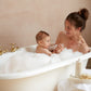Mother and baby enjoying belle enfant luxury vegan hypoallergenic luxury bubble bath together in foaming bath